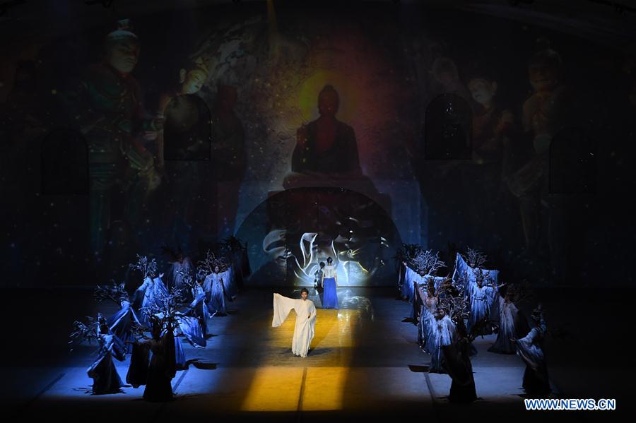 Artists perform in a desert landscape show on the history of Dunhuang in Dunhuang, northwest China