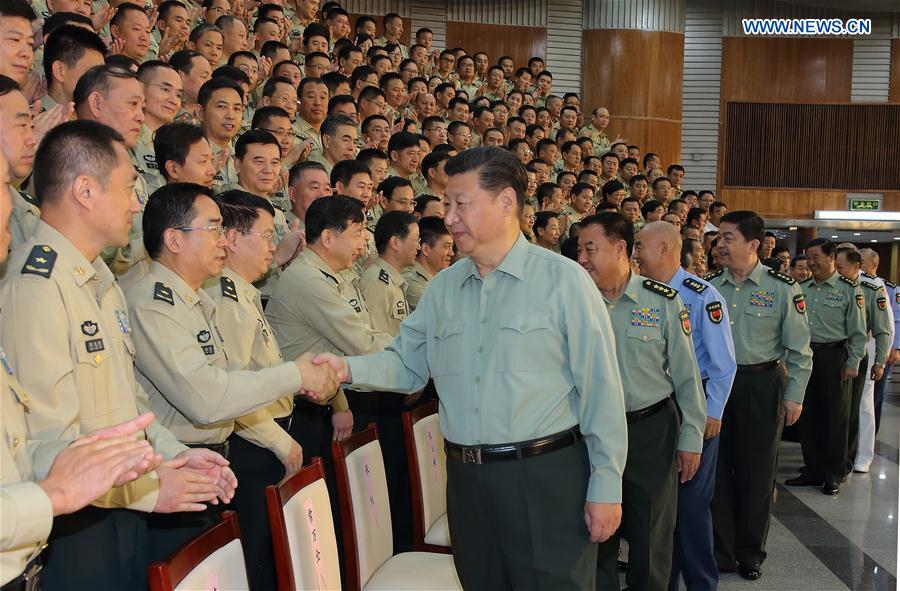 Chinese President Xi Jinping, also general secretary of the Communist Party of China (CPC) Central Committee and chairman of the Central Military Commission (CMC), shakes hands with delegates attending the first People