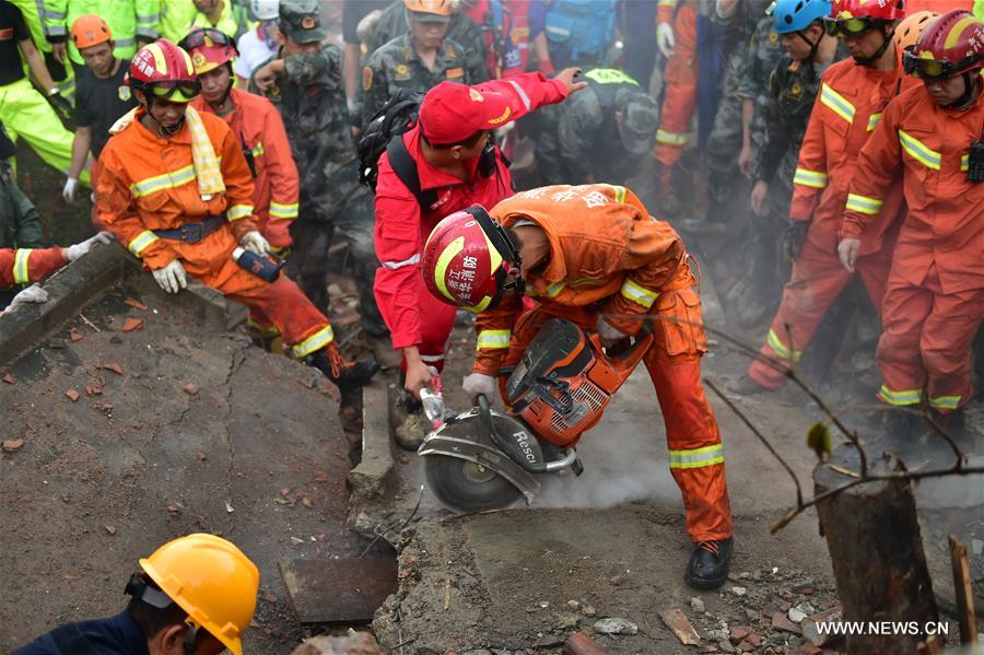 Rescuers search for survivors after a landslide hit Suichang County in Lishui, east China