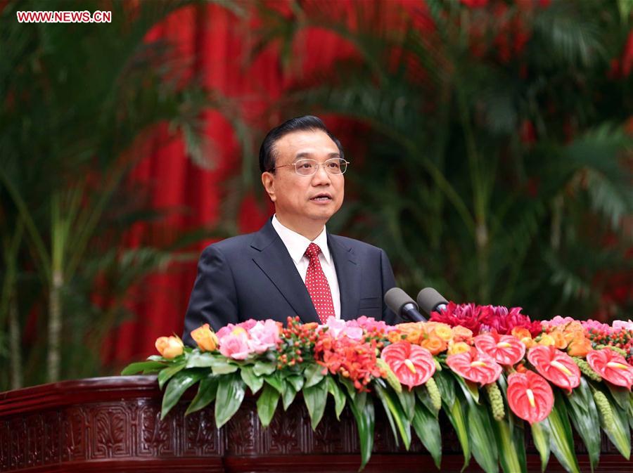 Chinese Premier Li Keqiang addresses a reception held by the State Council to celebrate the 67th anniversary of the founding of the People
