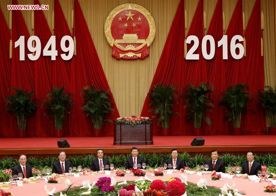 Chinese PresidentXi Jinping(C), PremierLi Keqiang(3rd L), and senior leadersZhang Dejiang(3rd R),Yu Zhengsheng(2nd L),Liu Yunshan(2nd R),Wang Qishan(1st L) andZhang Gaoli(1st R) attend a reception held by the State Council to celebrate the 67th anniversary of the founding of the People