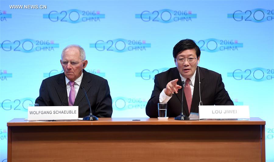 Chinese Finance Minister Lou Jiwei(R) speaks at a press conference on G20 Finance Ministers and Central Bank Governors Meeting at the headquarters of International Monetary Fund(IMF) in Washington D.C., the United States, Oct. 7, 2016. Global economy continued to face uncertainty and rising risks, Lou Jiwei said on behalf of the G20 economies on Friday. (Xinhua/Yin Bogu)