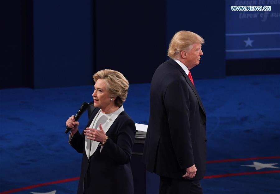 Democratic presidential candidate Hillary Clinton (L) speaks during the second presidential debate with Republican presidential candidate Donald Trump at Washington University in St. Louis, the United States, on Oct. 9, 2016. (Xinhua/Yin Bogu)  