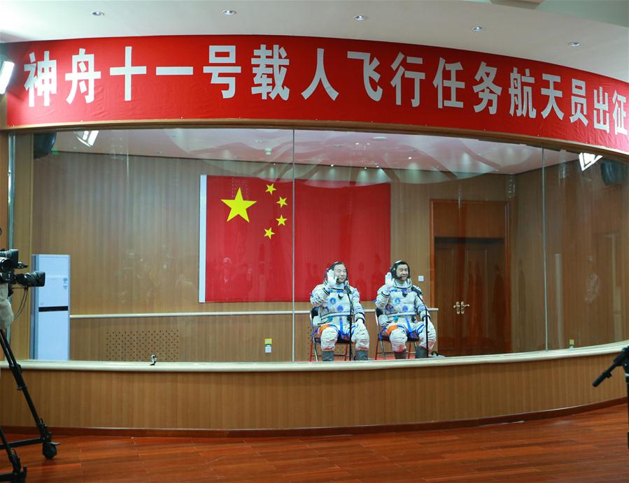 Taikonauts Jing Haipeng (L) and Chen Dong attend the see-off ceremony of the manned Shenzhou-11 mission at the Jiuquan Satellite Launch Center in Jiuquan, northwest China