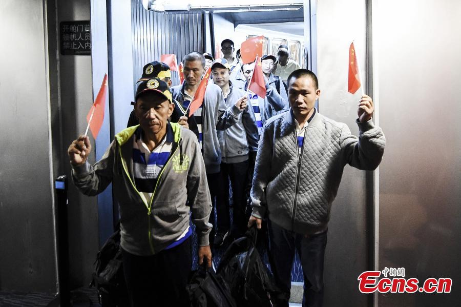 Chinese sailors released after being held captive by Somalia pirates for more than four years arrive at an airport in Guangzhou City, South China’s Guangdong Province, Oct. 25, 2016. One sailor continues to receive treatment in Kenya and the other nine returned to China on Tuesday. [Photo: China News Service]