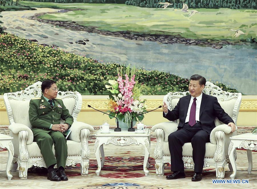 Chinese President Xi Jinping (R), also chairman of the Central Military Commission, meets with Myanmar