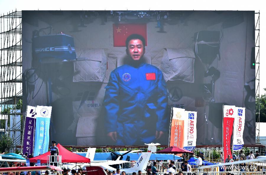 Photo taken on Nov. 1, 2016 shows a screen broadcasting Chinese astronaut Chen Dong sends his best wishes from the space lab Tiangong-2 to the on-going 11th China International Aviation and Aerospace Exhibition in Zhuhai, south China