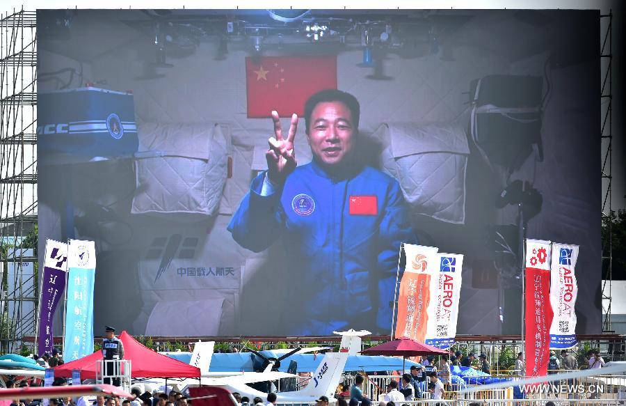 Photo taken on Nov. 1, 2016 shows a screen broadcasting Chinese astronaut Jing Haipeng sends his best wishes from the space lab Tiangong-2 to the on-going11th China International Aviation and Aerospace Exhibition in Zhuhai, south China