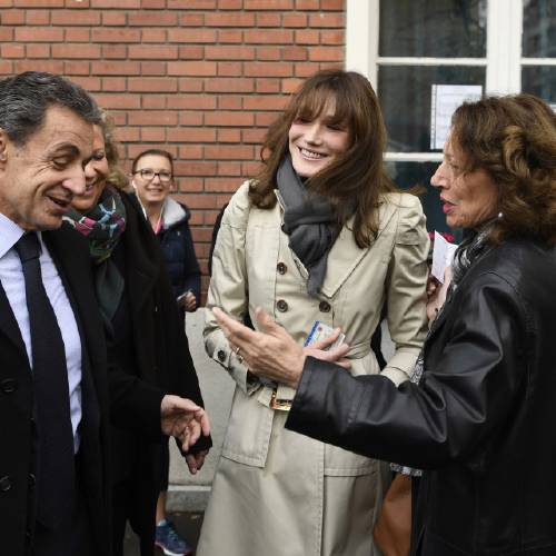  Former French President Nicolas Sarkozy and his wife Carla Bruni-Sarkozy, center, leave the polling station after casting their votes for the conservative primary election, in Paris, Sunday, Nov. 20, 2016. French conservatives are voting in a nationwide primary to choose their nominee for next year