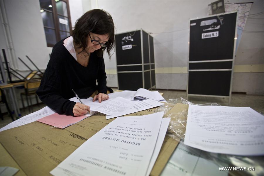 A staff member of a polling station checks information on the eve of the constitutional referendum in Rome, capital of Italy, on Dec. 3, 2016. On Dec. 4, voters will be called to have their say on a constitutional reform package, which the parliament had already approved with six consecutive readings in over two and a half years long debate. (Xinhua/Jin Yu)