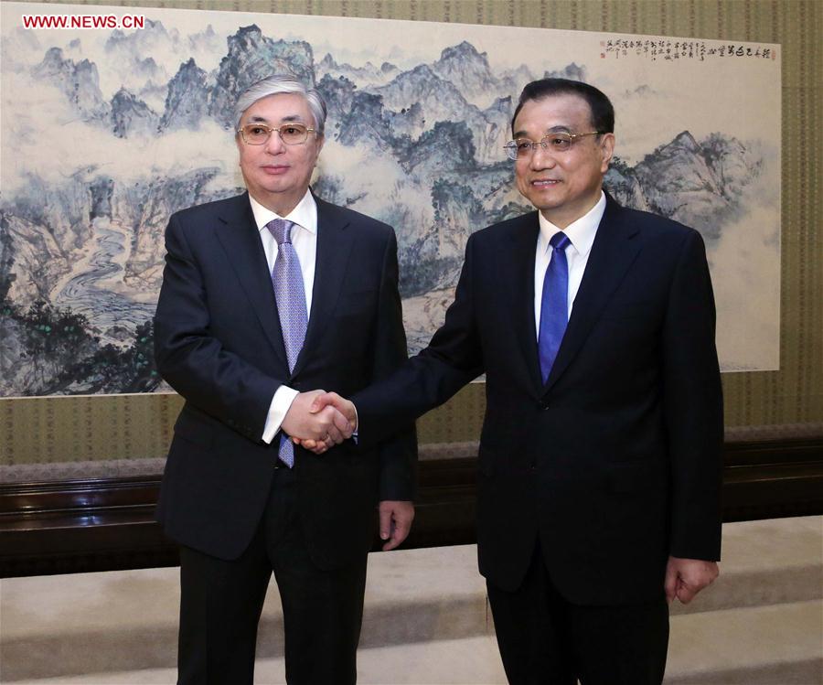 Chinese Premier Li Keqiang (R) meets with Chairman of the Senate of Kazakhstan Kassym-Jomart Tokayev in Beijing, capital of China, Dec. 6, 2016. (Xinhua/Liu Weibing)