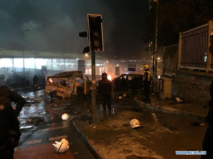 Policemen check the site of explosions in central Istanbul, Turkey, on Dec. 10, 2016. Two explosions hit central Istanbul on Saturday night, injuring 20 people, the authorities said. The blasts happened within 10 seconds at the conclusion of a football match in the district of Besiktas, and a car was seen burning in front of the stadium, the Haberturk daily said. (Xinhua)