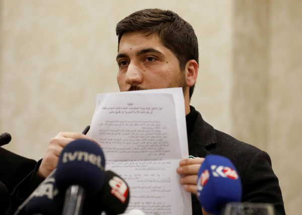 Osama Abu Zaid, a spokesman for the Free Syrian Army rebel alliance, shows the text of the agreement about a ceasefire between Syrian opposition groups and the Syrian government during a news conference in Ankara, Turkey, December 29, 2016. [Photo/Agencies]