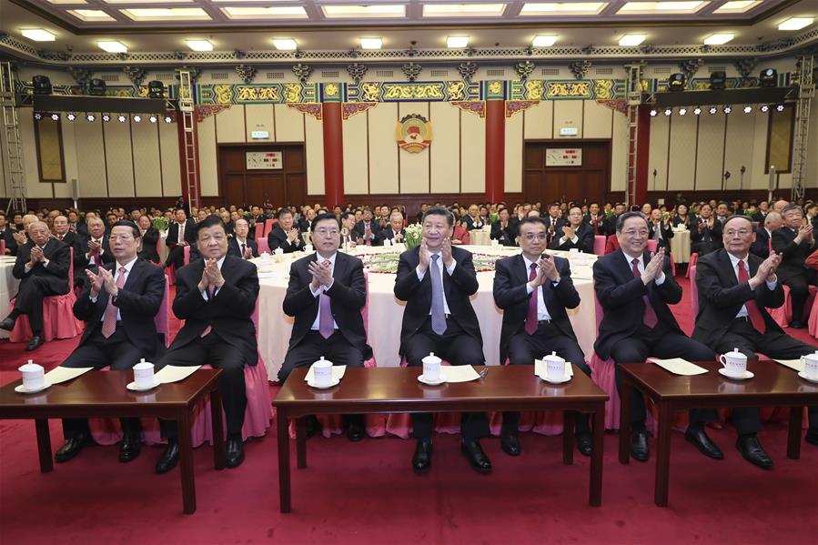 Top Communist Party of China (CPC) and state leaders Xi Jinping (C front), Li Keqiang (3rd R front), Zhang Dejiang (3rd L front), Yu Zhengsheng (2nd R front), Liu Yunshan(2nd L front), Wang Qishan (1st R front) and Zhang Gaoli (1st L front) attend a New Year gathering held by the Chinese People