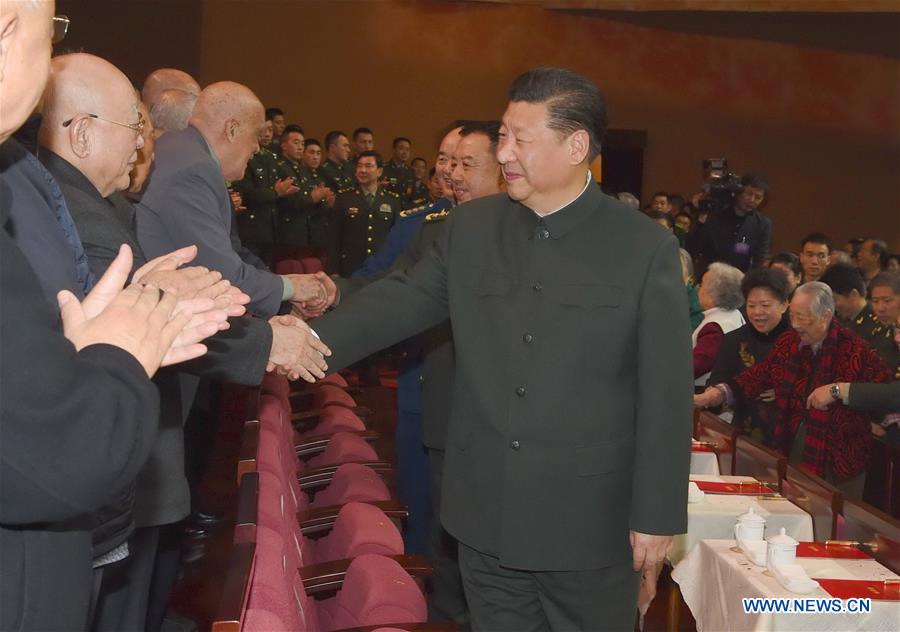 Chinese President Xi Jinping, also general secretary of the Communist Party of China (CPC) Central Committee and chairman of the Central Military Commission, shakes hands with military veterans and ex-officers at a festive art performance held for them in Beijing, capital of China, Jan. 13, 2017. Xi on Friday extended Spring Festival greetings to military veterans. (Xinhua/Li Gang)