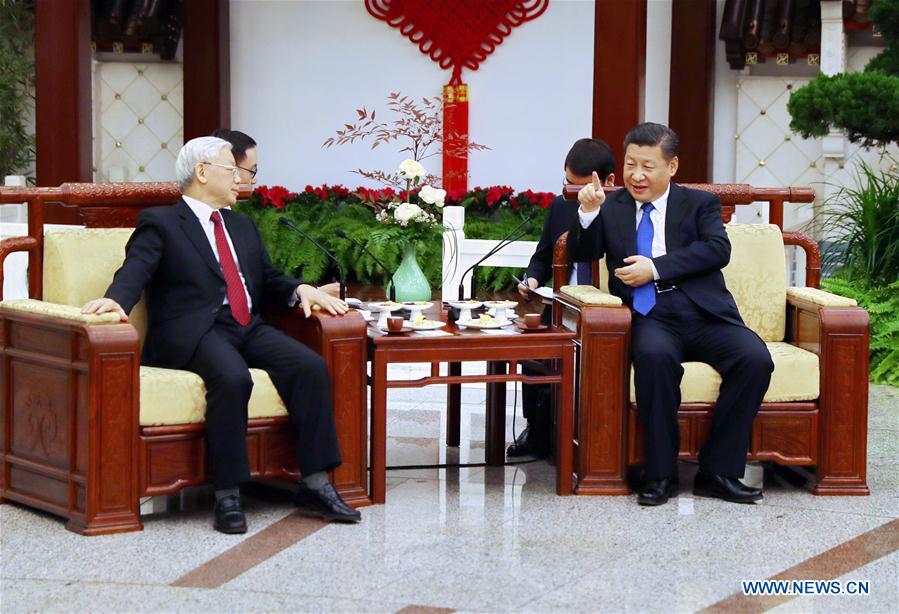 Chinese President Xi Jinping (R), who is also General Secretary of the Communist Party of China Central Committee, and Nguyen Phu Trong, General Secretary of the Communist Party of Vietnam Central Committee, have a tea chat after their talks in Beijing, capital of China, Jan. 12, 2017. (Xinhua/Ju Peng)