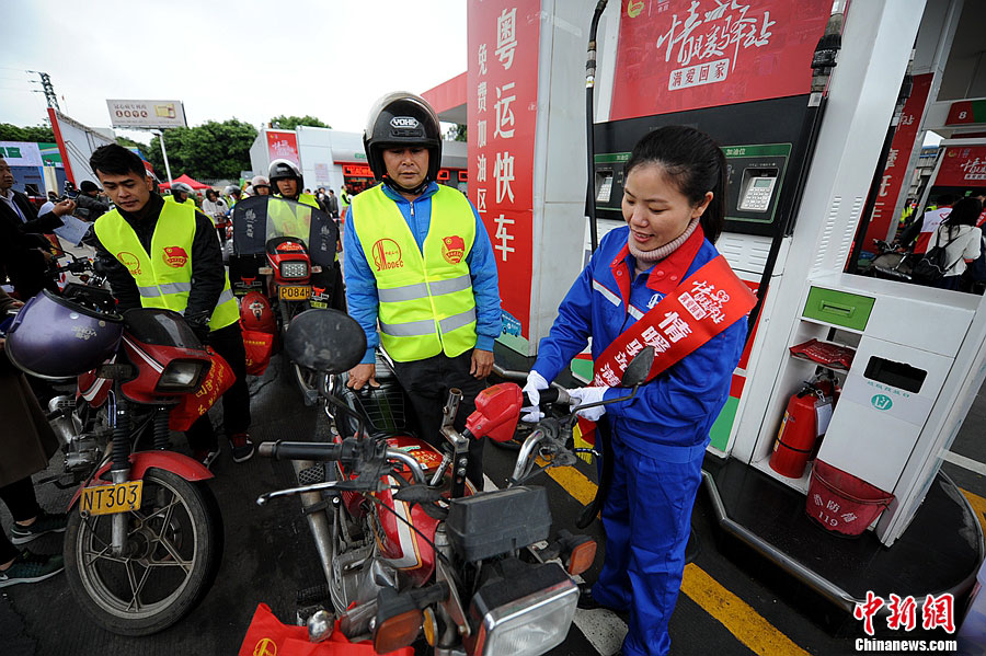 Motorcyclists get their vehicles fueled at Sinopec