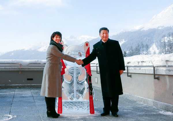 Chinese President Xi Jinping (R) and his Swiss counterpart Doris Leuthard shake hands as they launch the Sino-Swiss Year of Tourism next to a panda ice sculpture on the side line of the 47th annual meeting of the World Economic Forum (WEF) in Davos, Switzerland, January 17, 2017. [Photo/Xinhua]
