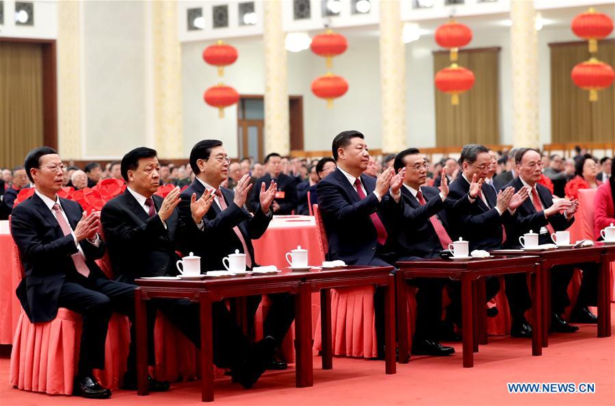 Chinese President Xi Jinping (C) and other top Chinese leaders Li Keqiang (3rd R), Zhang Dejiang (3rd L), Yu Zhengsheng (2nd R), Liu Yunshan (2nd L), Wang Qishan (1st R) and Zhang Gaoli (1st L) attend a reception for the Spring Festival with members of the public in Beijing, capital of China, Jan. 26, 2017. This year