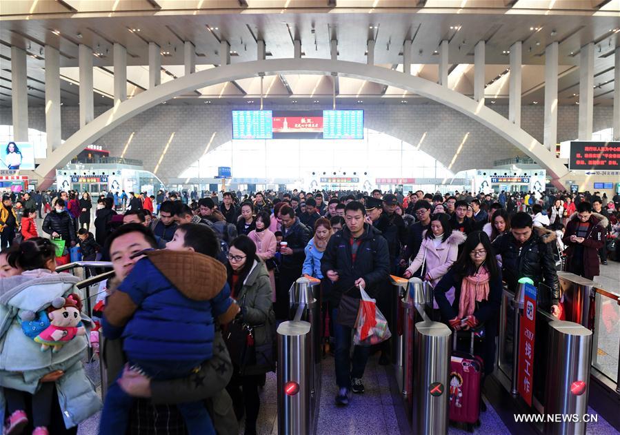 Passengers have their tickets checked at the Shijiazhuang railway station in Shijiazhuang, north China