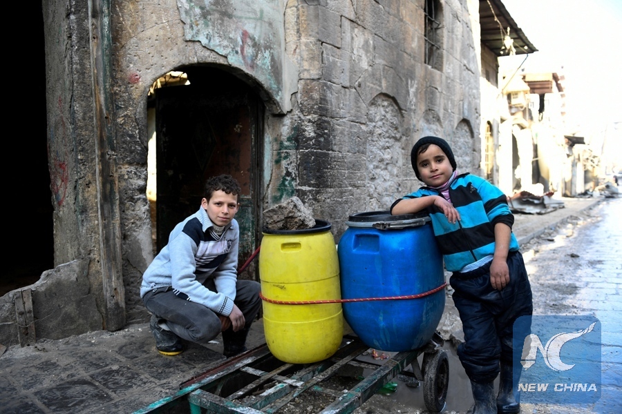 Boys are pictured beside a cart they use to carry water back to their home in the east Aleppo neighborhood of al-Mashatiyeh, Syria, in this handout picture provided by UNHCR on January 4, 2017. (Bassam Diab/UNHCR/Handout via REUTERS)