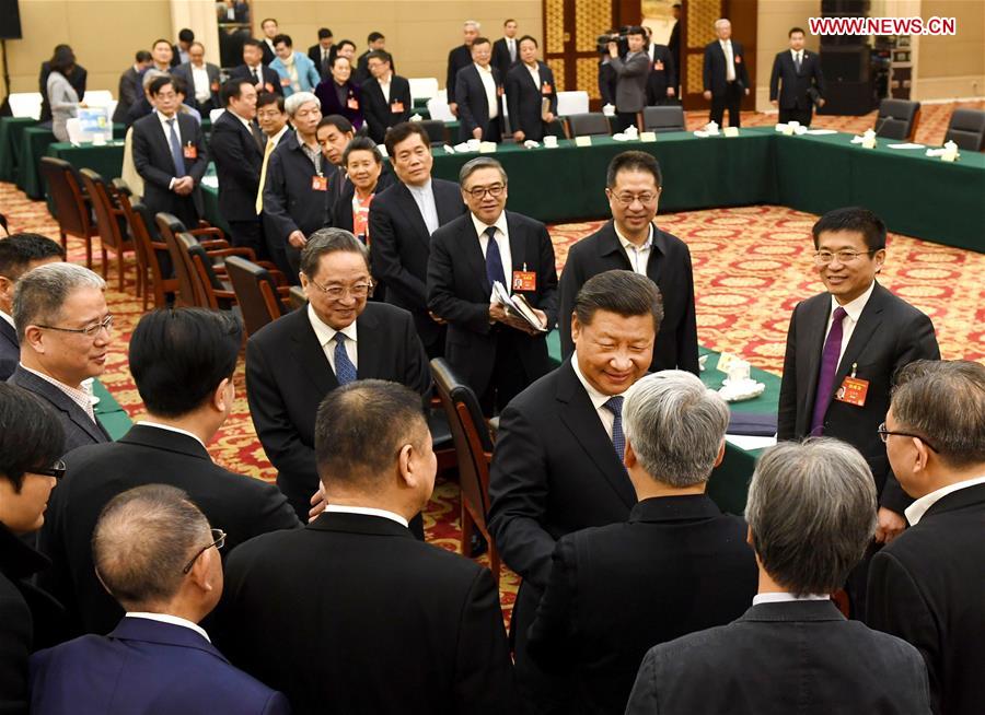 Chinese President Xi Jinping joins a panel discussion with political advisors from the China Association for Promoting Democracy, the Chinese Peasants and Workers Democratic Party and the Jiu San Society at the fifth session of the 12th National Committee of the Chinese People