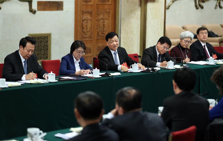 Liu Yunshan, a member of the Standing Committee of the Political Bureau of the Communist Party of China (CPC) Central Committee, joins a panel discussion with deputies to the 12th National People