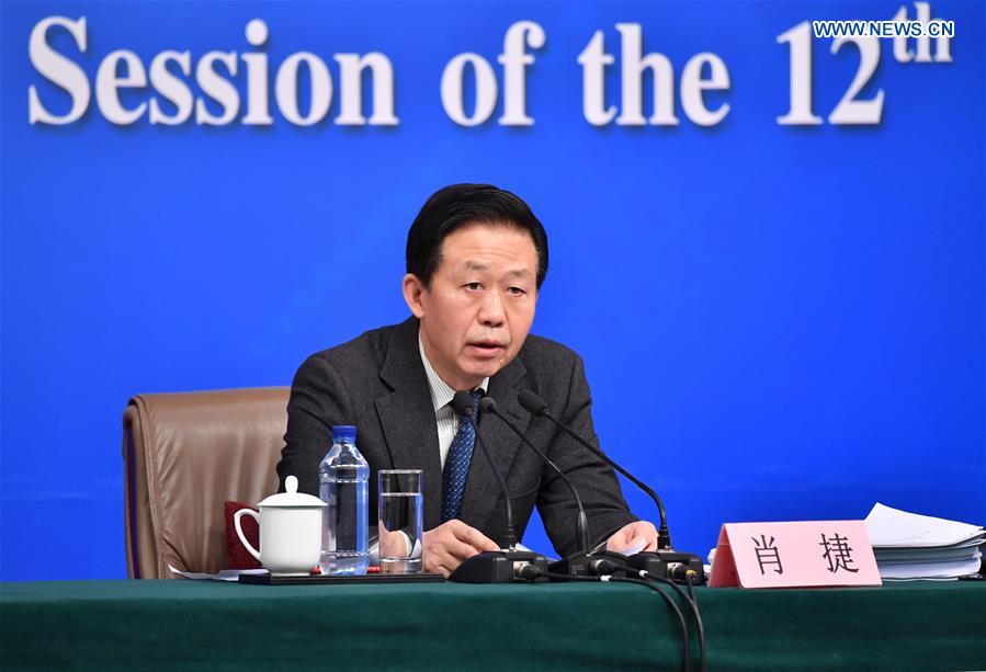Chinese Minister of Finance Xiao Jie answers questions on reform of fiscal and taxation system and financial work at a press conference for the fifth session of the 12th National People