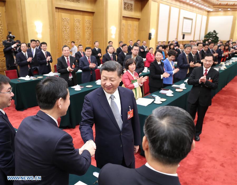 Chinese President Xi Jinping joins a panel discussion with deputies to the 12th National People