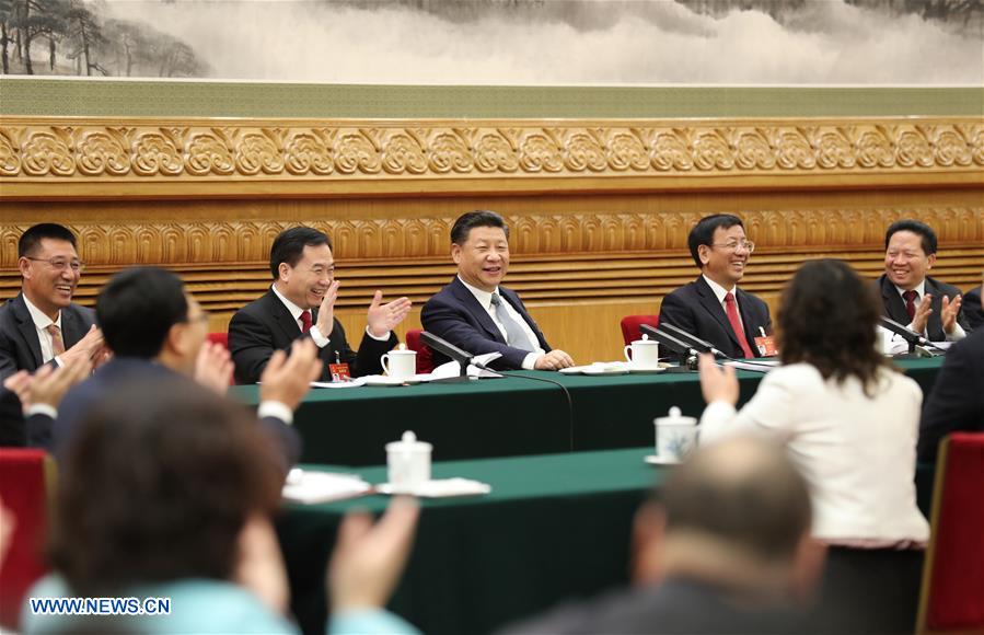 Chinese President Xi Jinping joins a panel discussion with deputies to the 12th National People