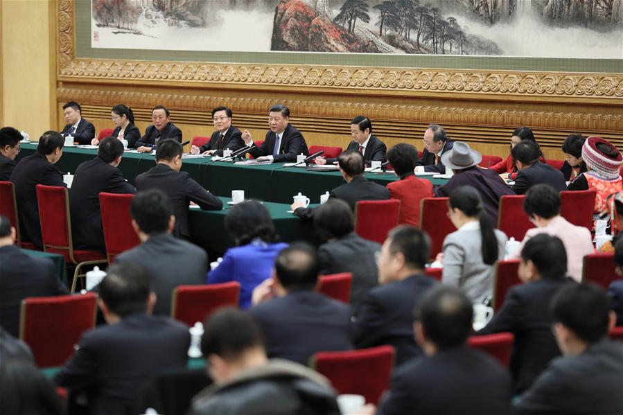 Chinese President Xi Jinping joins a panel discussion with deputies to the 12th National People