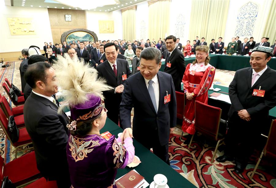 Chinese President Xi Jinping shakes hands with deputies to the 12th National People