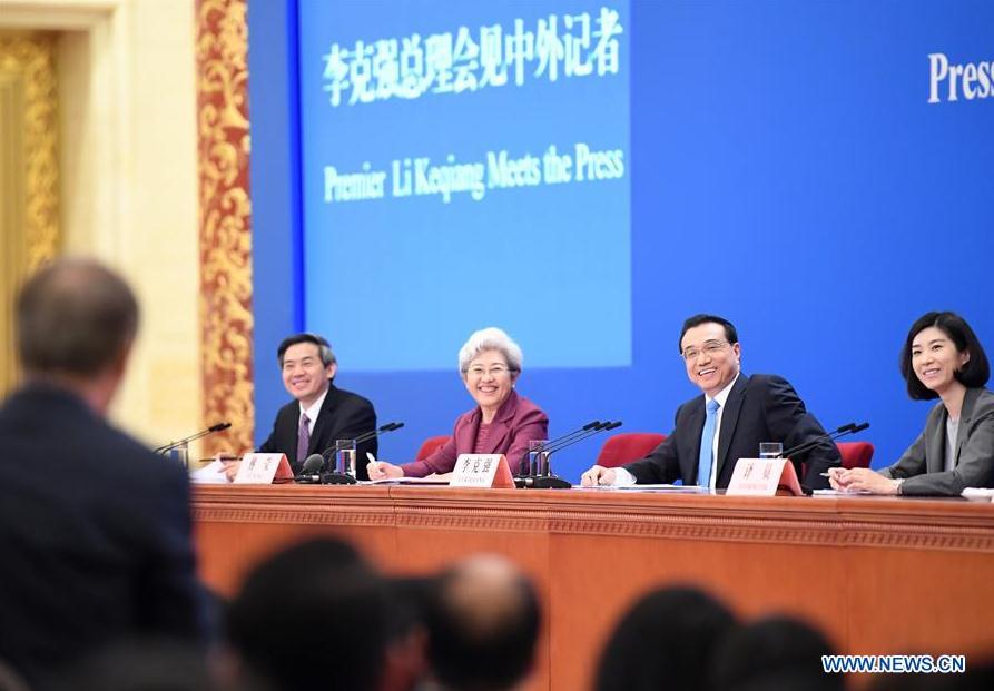 Chinese Premier Li Keqiang listens to a journalist