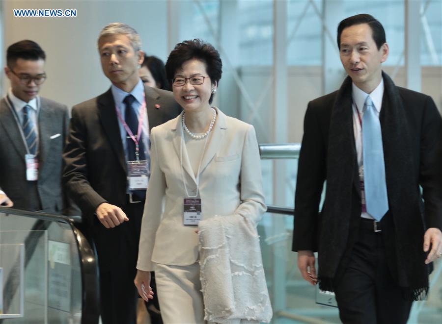 Lam Cheng Yuet-ngor (2nd R) arrives at the Hong Kong Convention and Exhibition Center before the voting for the fifth-term chief executive of China