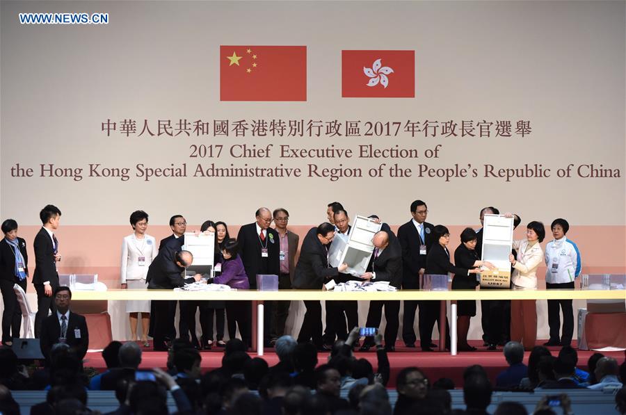 Officials open ballot boxes during the election for the fifth-term chief executive of China