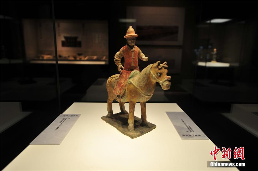 A pottery figurine of a man on horseback is displayed at the exhibition of antiques collected from the Ancient Tea Horse Route at Liaoning Provincial Museum in Shenyang, capital of Northeast China
