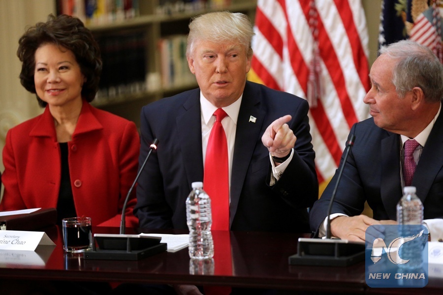 U.S. President Donald Trump speaks during a strategic and policy CEO discussion as Secretary of Transportation Elaine Chao and CEO of Blackstone Stephen Schwarzman listen in the Eisenhower Execution Office Building in Washington, the United States, April 11, 2017. (Xinhua/REUTERS)