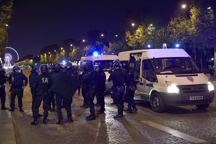 Police officers stand guard on Champs Elysees shopping street in Paris, France on April 20, 2017. One policeman was killed, and another severely injured in a shooting incident Thursday evening near the Champs Elysees shopping street in Paris. (Xinhua/Chen Yichen)