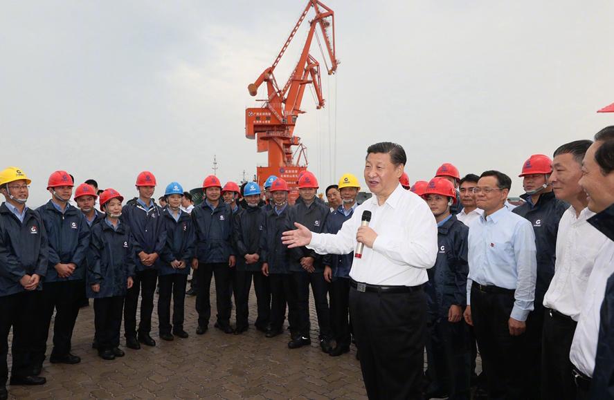 President Xi Jinping talks with workers at the Tieshangang Yard in Beihai, South China