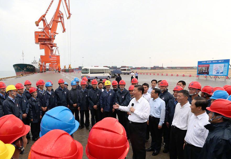 President Xi Jinping talks with workers at the Tieshangang Yard in Beihai, South China