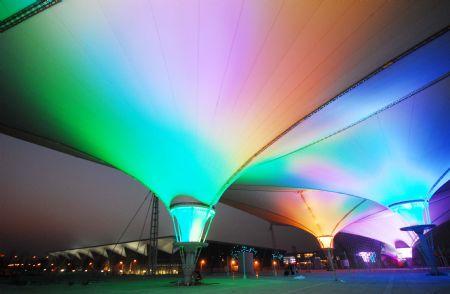 Photo taken on Jan. 12, 2010 shows the scenery of the Expo Axis during a trial illumination in the Expo Park in Shanghai, east China. Ninety percent of the construction work has been completed in the expo site by far. Workers are busy working to greet the 100 days count down to the opening of Shanghai World Expo on Jan. 21. (Xinhua Photo)