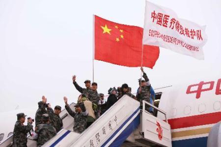 Members of Chinese medical care and epidemic prevention team wave before they board a plane to Haiti, in Beijing, capital of China, on Jan. 24, 2010. A 40-member Chinese medical care and epidemic prevention team left here for Haiti on Sunday afternoon on a chartered flight, which also carried 20 tonnes of medical supplies.(Xinhua/Chen Jianli)