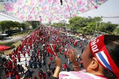 A supporter of former premier Thaksin Shinawatra cheers as others arrive on motorcycles to protest outside the base of Thai Army 11th Infantry Regiment in Bangkok March 15, 2010. REUTERS/Sukree Sukplang