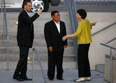 Ri Gun, director general of the North American affairs bureau of North Korea's Foreign Ministry (C), and U.S. principal deputy assistant secretary of defense Derek Mitchell (L) are greeted by the Institute on Global Conflict and Cooperation (IGCC) director Susan Shirk as they arrive for an informal dinner at the University of California in San Diego October 25, 2009. Ri was granted permission to attend meetings with private scholars in New York and San Diego over the next several days.North Korean leader Kim Jong-il has called for direct talks between Washington and Pyongyang, but the United States has viewed the request with caution.REUTERS/Mike Blake