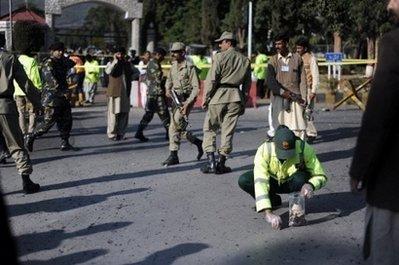 A rescue official collects evidence at the site of the suicide attack in Islamabad. A suicide bomber attacked Pakistan's navy headquarters in the capital Islamabad, killing a naval official and injuring 11 others in the latest blast in the Taliban-troubled nation.(AFP/Farooq Naeem) 