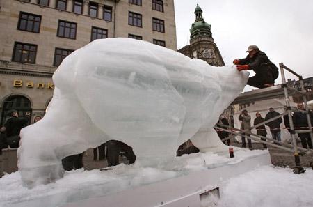 Mark Coreth, director of the Ice Bear Project, puts the finishing touches on an ice sculpture of a polar bear in downtown Copenhagen December 5, 2009. The installation is a part of an initiative to put focus on the consequences of global warming. (Xinhua/Reuters Photo)