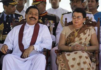 Sri Lankan President Mahinda Rajapaksa, left, laughs as his wife Shiranthi Rajapaksa looks on during the 62nd Independence Day celebrations in Kandy, Sri Lanka, Thursday, Feb. 4, 2010. (AP Photo/Eranga Jayawardena)