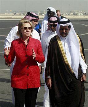 U.S. Secretary of State Hillary Clinton, left, is welcomed by the Qatari Ambassador to U.S. Ali Al Hajri, right, at the Doha International Airport in Doha, Qatar, Sunday, Feb. 14, 2010. (AP Photo/Maneesh Bakshi)