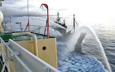 In this photo taken Wednesday, Feb. 17, 2010 released by the Institute of Cetacean Research of Japan, anti-whaling group Sea Shepherd's ship Steve Irwin, background, and the Japanese whaling ship Nisshin Maru use water cannons to each other in Antarctic Sea. The U.S.-based activist group, sends vessels to confront the Japanese fleet each year, trying to block them from firing harpoons at the whales. (AP Photo/Institute of Cetacean Research) 