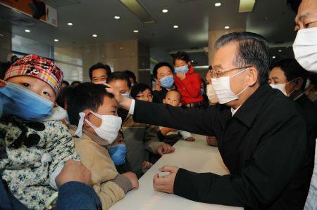 Chinese Premier Wen Jiabao (R2) talks with patients at the Beijing Children's Hospital in Beijing, capital of China, Oct. 31, 2009. Premier Wen visited A/H1N1 patients and medical staff at the Beijing Children's Hospital in Beijing on Saturday.(Xinhua/Rao Aimin)